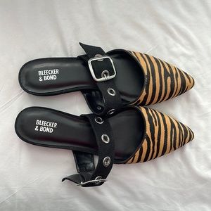 Bleecker and Bond zebra print flat mules.
